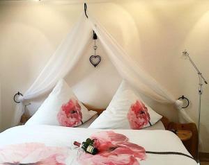 ボルテンハーゲンにあるFerienappartment-Trautschのベッドルーム1室(ピンクの花が咲くベッド1台付)