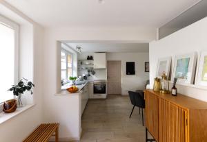 a kitchen and dining room with white walls and a table at Apartment Close to the Beach in Flensburg +15 photos