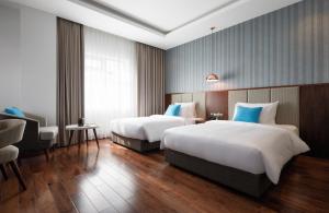 Ліжко або ліжка в номері D'Lecia Ha Long Hotel