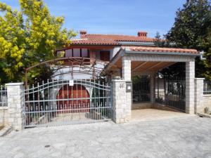 a gate in front of a house with a garage at Beautiful-Banjole-Beachside-Apartment-A2-150m-from-the-beach in Banjole