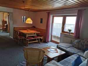 a living room with a couch and a table at Haus Haidweg Wohnung 4 in Haidmühle