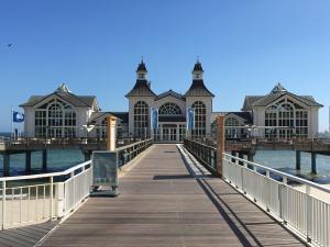 a pier with a large building on the water at Ferienappartement-Granitz-02 in Ostseebad Sellin