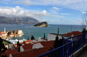 a view of a town and the ocean with mountains at Belvedere Apartments in Budva