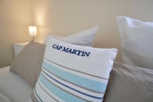 a pillow with cap marlin on it sitting on a bed at Ferienappartement-Moenchgut-21 in Ostseebad Sellin