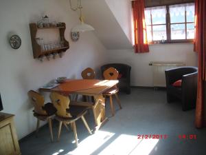 a dining room with a table and chairs at Allgaeublick-App23-Gaestehaus-in-Bad-Hindelang in Bad Hindelang