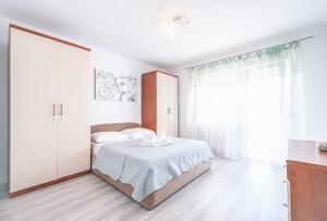 Postel nebo postele na pokoji v ubytování Apartments Vukic