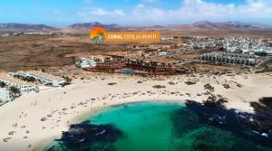 an aerial view of a beach and a resort at Coral Cotillo Beach in El Cotillo
