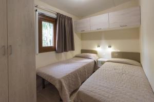 Posteľ alebo postele v izbe v ubytovaní Camping Arcobaleno