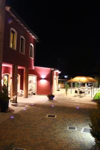 a building at night with a table and a tent at Albergo Delle Industrie in Casalmaggiore