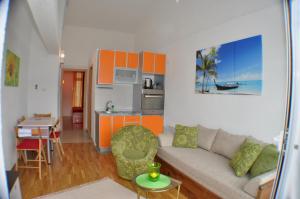 a living room with a couch and a kitchen at Belvedere Apartments in Budva