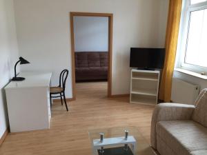 a living room with a couch and a table at Kleine-Mietidee in Markranstädt