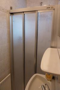 a shower stall in a bathroom with a toilet at Ferienwohnung-Marita in Carolinensiel