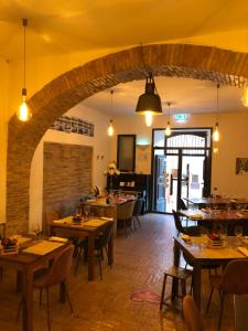 a restaurant with tables and chairs and a brick wall at Boutique Hotel Palazzo Corso Umberto in Boiano