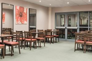 a large room filled with tables and chairs at Days Inn by Wyndham Donington in Castle Donington
