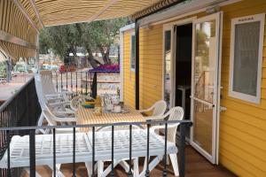 patio con mesa y sillas en el balcón en Camping Edy, en Diano Marina