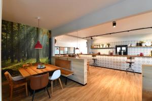 a dining room with a table and a bar at Sportpark Hugstetten in Hugstetten