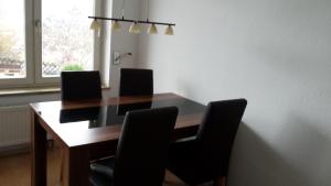a dining room table with four chairs around it at Ferienwohnung-Burgblick-in-Neuravensburg in Haggen