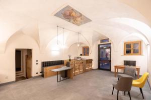 a kitchen and dining room with a ceiling with a painting at Curt di Clement Eco Mobility Hotel in Tirano