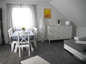 a dining room with a table and a dresser at Ferienwohnung-Bullerby in Barkelsby