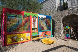 eine Spielstruktur mit einem Spielplatz vor einem Gebäude in der Unterkunft Camping Edy in Diano Marina