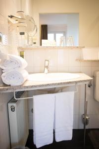 a bathroom with a sink and towels on a counter at Domicil Leidinger in Saarbrücken