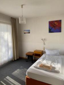 a hotel room with a bed and a table at Hotel Seehaus in Horn-Bad Meinberg