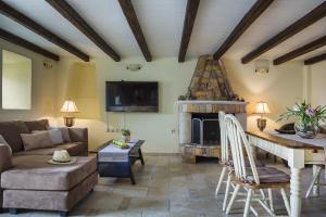 a living room with a couch and a fireplace at Villa Fantastic View in Khalikerí