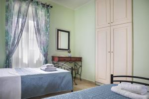 a bedroom with two beds and a mirror and a window at Villa Fantastic View in Khalikerí +21 photos