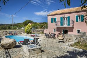 a villa with a swimming pool and a house at Villa Fantastic View in Khalikerí