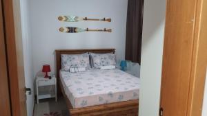 מיטה או מיטות בחדר ב-"Simplesmente um Paraíso"