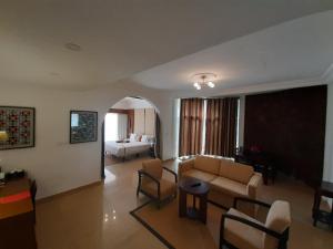 a living room with a couch and a table at Iris Hotel in Dakar