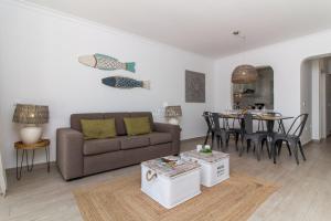 a living room with a couch and a table at Blue Apartment Balaia Space - By Dalma Portuguesa in Albufeira