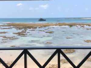 a view of the beach with a boat in the water at Pousada Tranquila in Morro de São Paulo