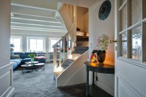 a living room with a staircase and a couch at Suite Die 12 in Kampen