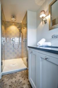 a bathroom with a shower and a sink at Suite Die 12 in Kampen