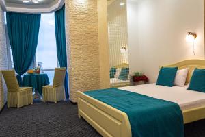 een hotelkamer met een bed en een tafel en stoelen bij Arkadia apartment with sea view in Odessa