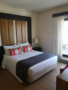a bedroom with a large bed and a large window at Hotel Lisboa in Lisbon