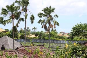 a view from the roof of a house with palm trees at EUFORIA Guest House in Canggu