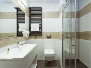 a bathroom with a toilet and a sink and a shower at InterHotel in Wrocław