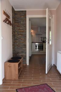 a hallway of a kitchen with a brick wall at Bungalow-Gartenzauber in Grube