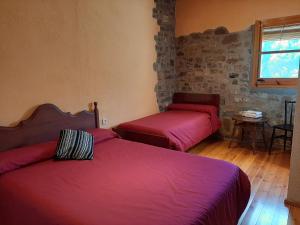 A bed or beds in a room at Casa Rural Más Pujol