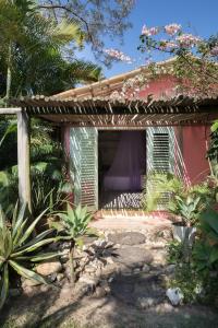 ein kleines rosafarbenes Haus mit einem lila Dach in der Unterkunft Casas da Vila in Trancoso