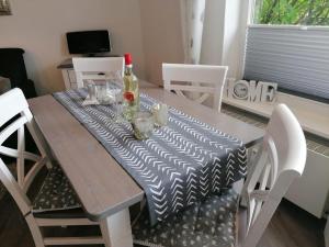 a dining room table with a black and white table cloth at Nordmarkhof in Westerland (Sylt)