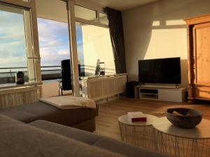 a living room with a couch and a flat screen tv at Beachhouse-Staberdorf in Staberdorf