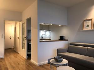 a living room with a couch and a table at Beachhouse-Staberdorf in Staberdorf