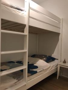 two bunk beds in a room with a bed at Beachhouse-Staberdorf in Staberdorf