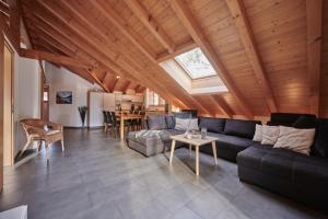 a living room with a couch and a table at Apartment Staubbach, Best views, Spacious, Family friendly in Lauterbrunnen