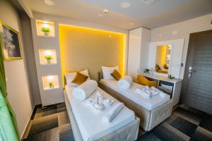 a hotel room with two beds and a mirror at Hotel River in Bijeljina +57 photos