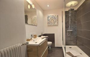 a bathroom with a toilet and a sink and a shower at City Bagot in Saint-Brieuc