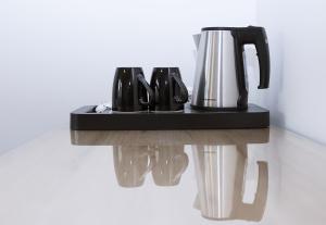 a coffee maker sitting on a black shelf at InterHotel in Wrocław